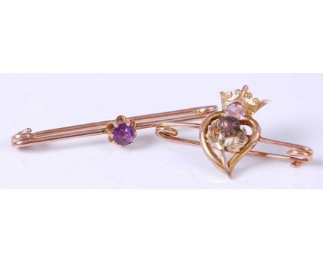 A 9ct gold and amethyst set safety pin brooch, 2.5g, together with one other yellow metal amethyst crown &amp; thistle safety