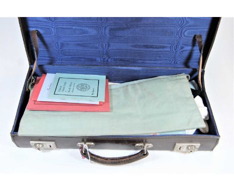 A leather case of Masonic regalia, to include sash, manuals etc