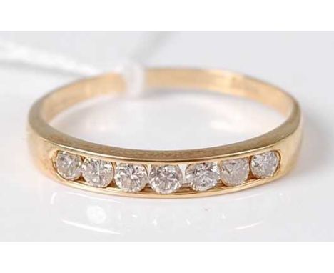 An 18ct gold diamond half eternity ring, the seven channel set brilliants weighing 0.5ct, 2.6g, size U