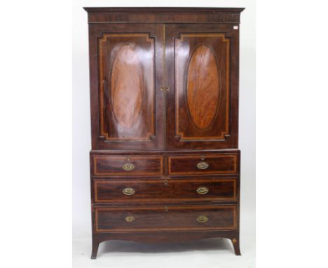 A 19TH CENTURY MAHOGANY LINEN PRESS the panel doors with decorative inlay including oval satinwood panels and with slides wit