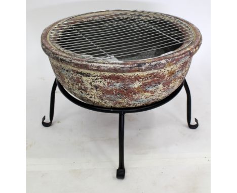 A CERAMIC SEMI-SPHERICAL BARBECUE with stainless steel grill and painted iron stand, 42cm diameter