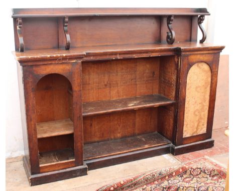 A LATE 19TH / EARLY 20TH CENTURY STAINED PINE BOOKCASE with a raised back with scrolling supports above an adjustable shelf, 