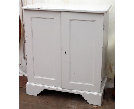 AN ANTIQUE WHITE PAINTED PINE FLOOR STANDING CUPBOARD with panel doors and bracket feet, 89cm wide x 44.5cm deep x 101.5cm hi