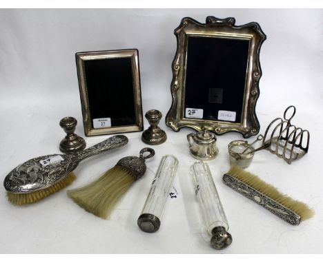 A SELECTION OF SILVER PHOTOFRAMES silver toast rack, brushes, a pair of candlestick holders, scent bottles, condiment pot etc