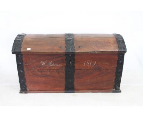 A 19TH CENTURY GERMAN OAK DOME TOPPED TRUNK with iron mounts, later painted and dated 1869, 136cm wide x 63cm deep x 72cm hig