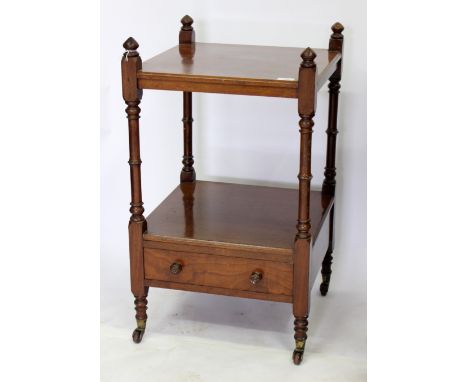 A VICTORIAN MAHOGANY LOW WHATNOT with turned supports, frieze drawer and turned tapering legs terminating in ceramic castors 