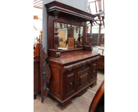 A CONTINENTAL WALNUT SIDEBOARD the upper section with mirrored back and carved decoration with outset fluted turned pilasters