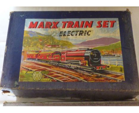 A boxed Marx O Gauge tin plate electric train set, 3 rail, oval track, with lithographic decoration. Along with a boxed Bayko