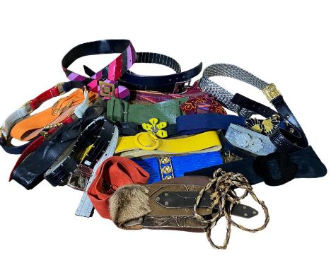 A collection of belts, mostly 70s and 80s to include leather, suede and fabric., one has a large, hallmarked silver clasp wit