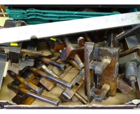 Box of vintage plough planes and a well used metal spirit level