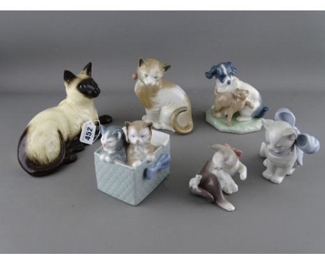 Royal Doulton model of a Siamese cat, no. 1559 and five porcelain models of cats by Lladro and Nao