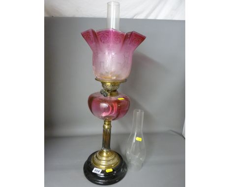 Victorian brass reeded column oil lamp with cranberry tinted glass reservoir and etched shade