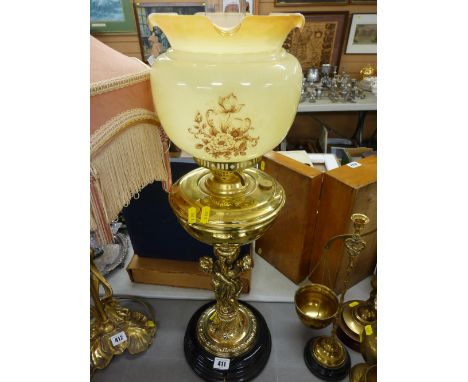 Good looking brass cherub decorated oil lamp with shade