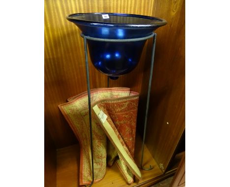 Deep Bristol blue glass basin on a tripod metal high stand and an oblong Laura Ashley rug in terracotta