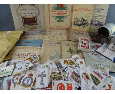 Collection of loose and mounted cigarette cards, quantity of vintage coinage, boxed Red Cross Society medal etc