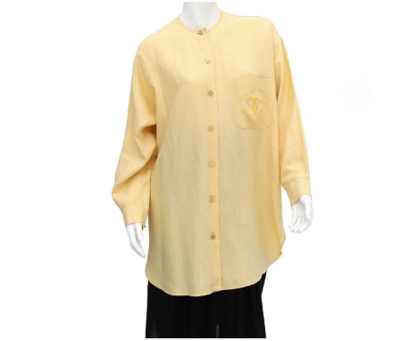 A Chanel Boutique yellow blouse, the blouse has an external pocket with the CC logo embroidered and gold-colored CC logo butt