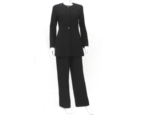 A black Chanel Boutique suit with blazer and trousers. The blazer has two internal pockets and a round neckline. The trousers