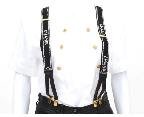 A pair of Chanel bracers. Black and white with gold tone details. Collector's item. 