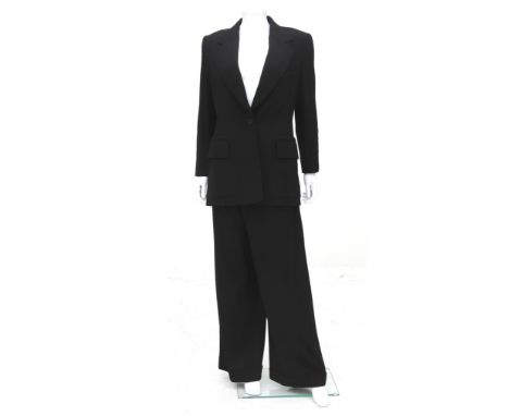 A black Hermès two-piece suit with light pinstripe. Including original garment bag. The blazer is made with a reverse necklin