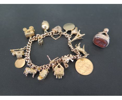 A mid 20th century 9ct gold curb-link bracelet - Suspending an assortment of sixteen charms, to include a fine gold sovereign