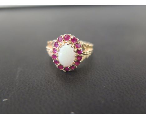 An opal and ruby cluster ring - Stamped 10K - Ring size N - Weight approx 3.3gms
Condition Report: Good - With light surface 