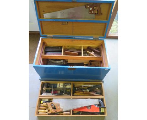 An old painted tool chest with contents of woodworking tools including planes, chisels, saws - Height 44cm x Width 88cm x Dep