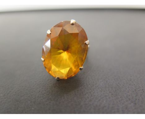 A yellow sapphire single-stone ring - Possibly synthetic - Stamped 14K - Ring size P - Weight approx 9.2gms
Condition Report: