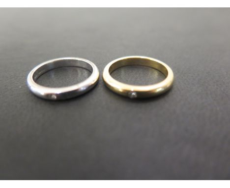 Two 18ct gold band rings - Each with brilliant-cut diamond highlight - Hallmarked London - Ring size J - Weight approx 6.9gms