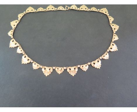 A 9ct gold fancy-link panel necklace - The scalloped triangular-shape links to the flower spacer links - Hallmarked Birmingha