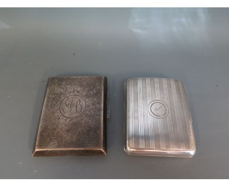 Two George V cigarette cases one with engine turned detail, the other having elaborate scroll work - Total approx weight 5 tr
