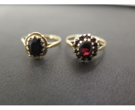 Two 9ct gold single-stone rings - To include garnet and sapphire - Ring size O - Hallmarked London and Birmingham - Weight ap