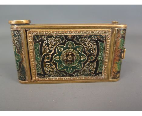 A compact in the form of a camera decorated in leather with foliate design  three compartments, one lipstick, one for manicur