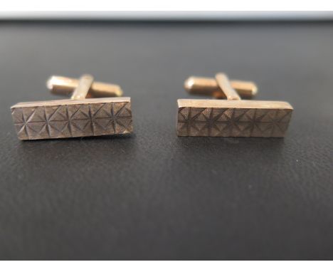 A pair of 9ct gold cufflinks - The textured rectangular panels to the swivel-back fittings - Hallmarked London - Length of pa