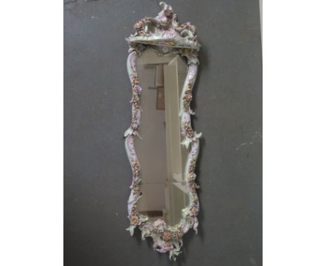 A tall encrusted Continental porcelain foliate mirror with lower shelf - Height 92cm 
Condition report: Damage to mirror and 