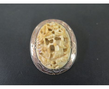 A late Victorian gold carved ivory brooch - Width 4.3gms - Weight approx 13.8gms
Condition Report: Good to fair - With light 