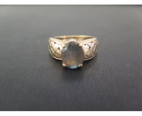 A 9ct gold gem-set single-stone ring - Believed to be labradorite - Hallmarked Birmingham - Ring size N 1/2 - Weight approx 4