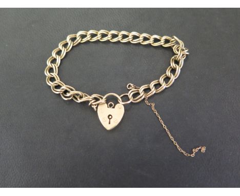 A 9ct gold fancy-link bracelet - To the padlock clasp - Hallmarked London - Length 17.5cms - Weight approx 12.3gms
Condition 