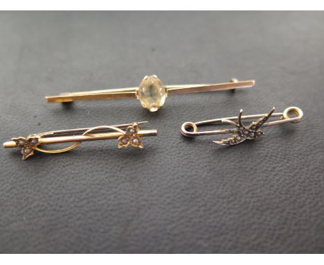A citrine bar brooch - Width 6cms - Together with a swallow brooch and a foliate brooch, both set with seed pearls - Each app