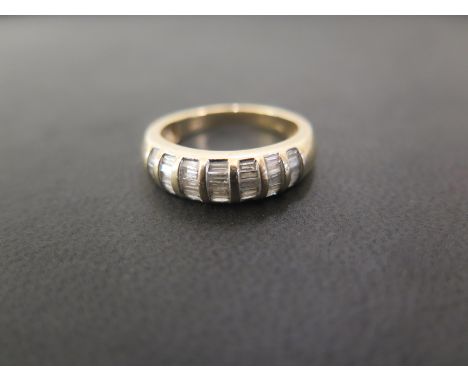 A 9ct gold baguette-cut diamond five-row band ring - Diamond weight 0.50ct, stamped to band - Hallmarked Sheffield - Ring siz