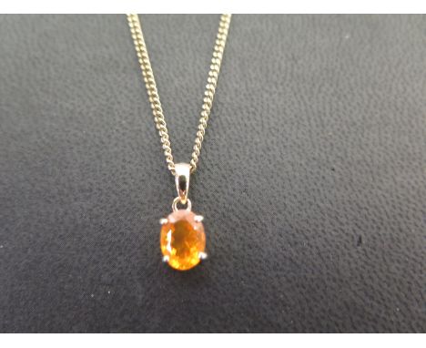 A 9ct gold fire opal pendant - Suspended from a curb-link chain - Hallmarked Birmingham - Length of pendant 1.5cms - Length o