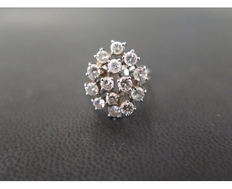 An 18ct gold diamond dress ring - The brilliant-cut diamond openwork cluster to the bifurcated shoulders and grooved band - E