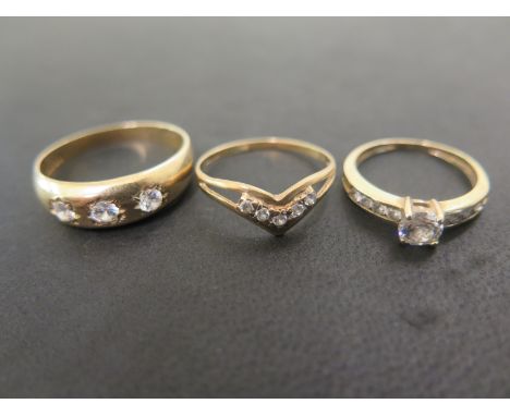 Three 9ct gold cubic zirconia dress rings - Hallmarked Birmingham and London - Ring sizes M, Q and X - Total weight approx 6.