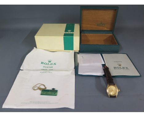 A Ladies 14ct yellow gold Rolex Oyster Perpetual Automatic wristwatch on crocodile skin strap, the champagne face with gold b