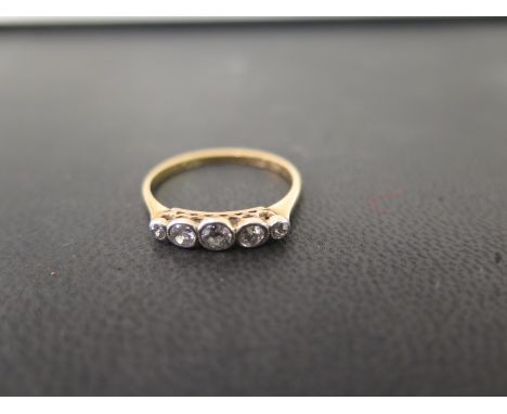 A diamond collet-set five-stone ring - Stamped 18ct - Ring size N 1/2 - Weight approx 1.8gms
Condition Report: Good to fair -