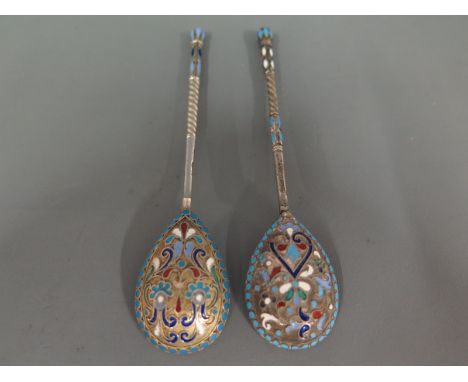 Two Russian silver and enamel spoons makers mark BA with varicoloured foliate decoration on a matted background, the handles 