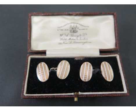 A pair of cufflinks - Each designed as alternating white enamel and textured lines - Stamped 9ct - Weight approx 5.9gms
Condi