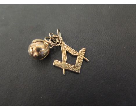 A 9ct gold Masonic compass and square charm - Hallmarked London - Length 2.2cms - Weight approx 1.9gms - Together with a silv