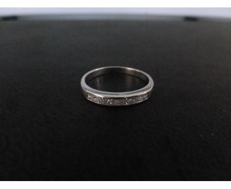 An 18ct gold diamond ring - The square-shape diamond line within a channel setting - Hallmarked Sheffield - Diamond weight 0.