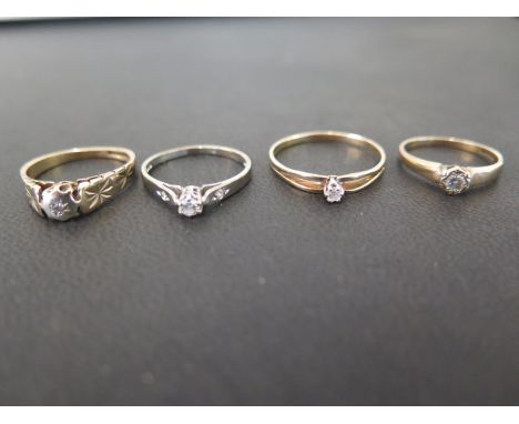 Four 9ct gold diamond single-stone rings - One with diamond-set shoulders - Hallmarked London and Birmingham - Ring sizes J -