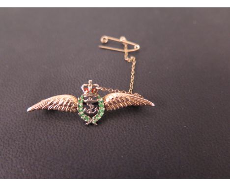 A 9ct gold sweetheart brooch - With enamel and anchor detail to the textured wings - Hallmarked Birmingham, 1956 - Width 4.5c